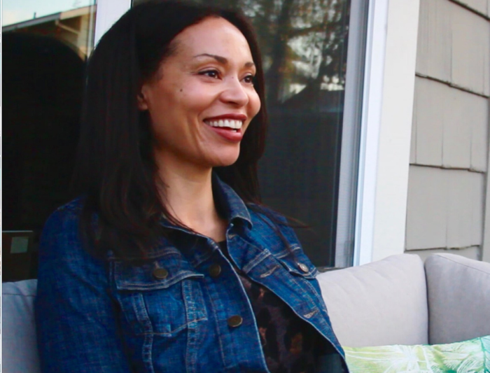 Woman seated outside, smiling